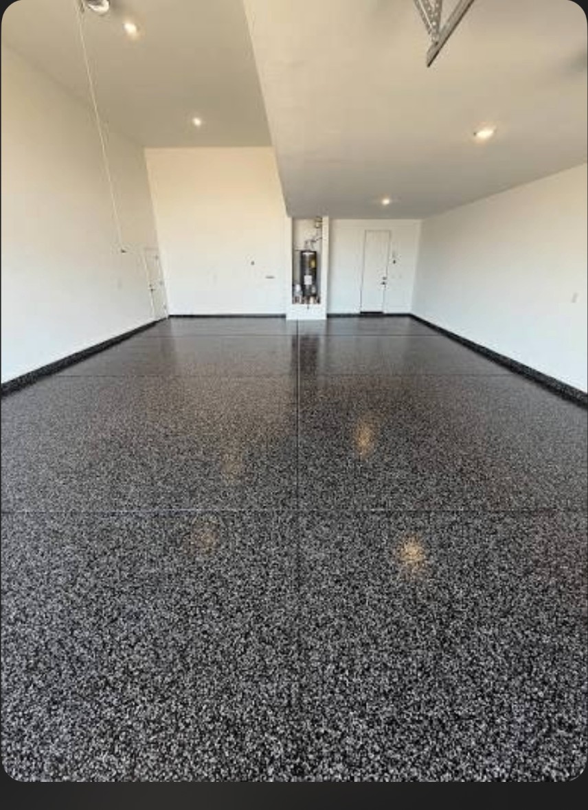 Raven dark gray and black epoxy flake floor in a bright empty garage